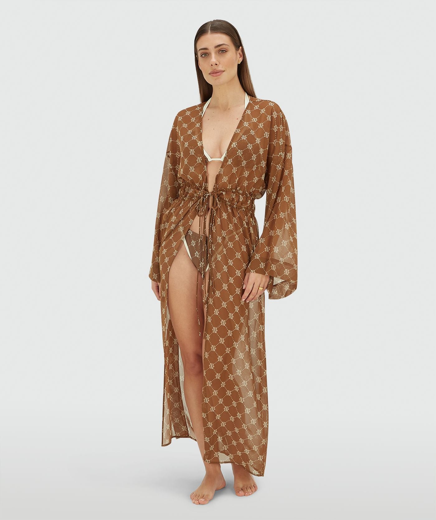 Image 36: Model draagt een oversized kimono met logoprint in de kleur Brown